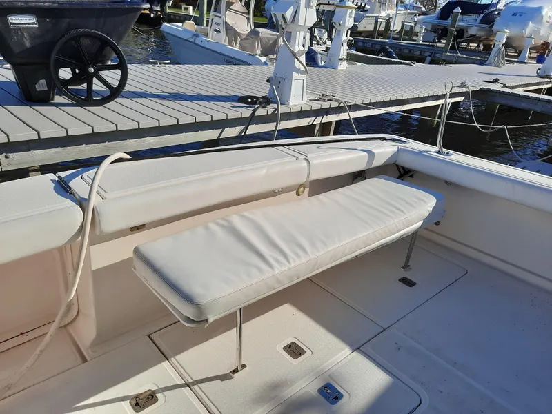 Slide: The Image of 2008 Tiara Yachts 3900 Convertible boat with cushioned seating at the dock. - 15
