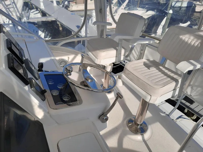 Slide: The Image of Helm station of a 2008 Tiara Yachts 3900 Convertible with white captain chairs. - 21