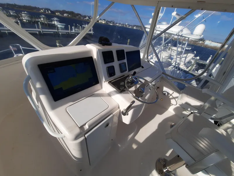 Slide: The Image of 2008 Tiara Yachts 3900 Convertible helm station with navigation screens and steering wheel. - 22