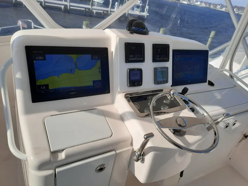 Slide: The Image of 2008 Tiara Yachts 3900 Convertible helm with navigation screens and steering wheel. - 24