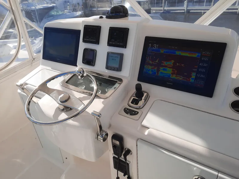 Slide: The Image of 2008 Tiara Yachts 3900 Convertible helm with navigation screens and controls. - 26