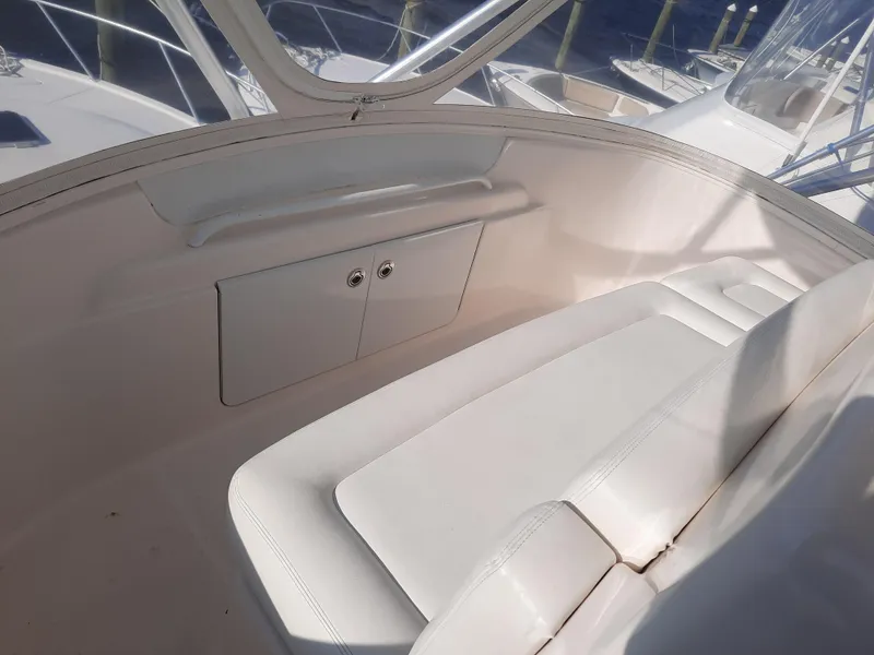 Slide: The Image of 2008 Tiara Yachts 3900 Convertible interior seating area with storage compartment. - 32