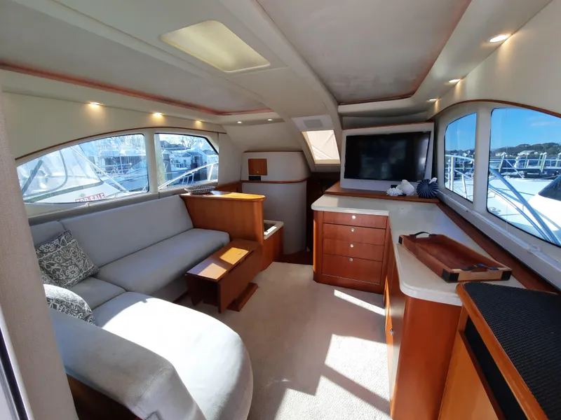 Slide: The Image of Interior of 2008 Tiara Yachts 3900 Convertible with sofa, TV, and wooden cabinetry. - 35
