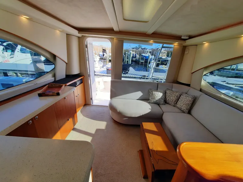 Slide: The Image of Interior of 2008 Tiara Yachts 3900 Convertible with modern furnishings and large windows. - 38
