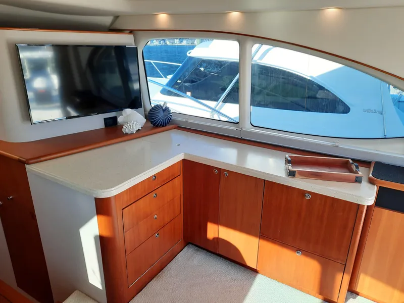 Slide: The Image of Interior of 2008 Tiara Yachts 3900 Convertible with TV and wooden cabinetry. - 41