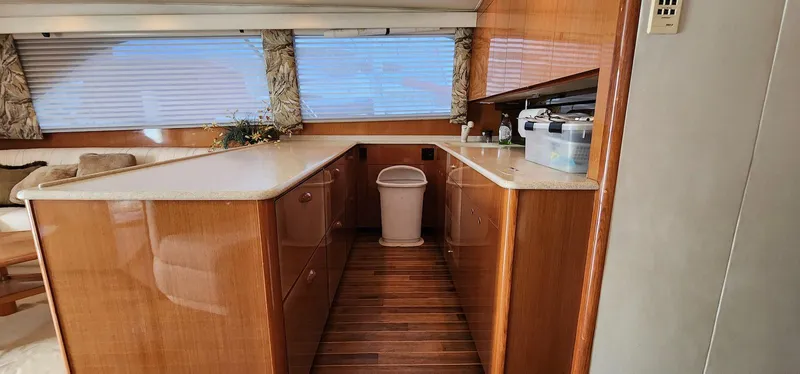 Slide: The Image of Interior of 2000 Viking 55 Convertible yacht with wooden cabinetry and countertops. - 13