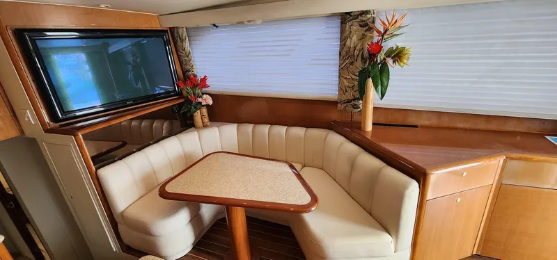 Slide: The Image of Interior of 2000 Viking 55 Convertible yacht with cozy dining area and elegant decor. - 14