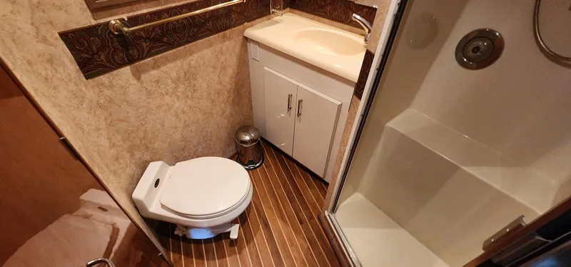 Slide: The Image of Bathroom interior of 2000 Viking 55 Convertible yacht with toilet, sink, and shower. - 16