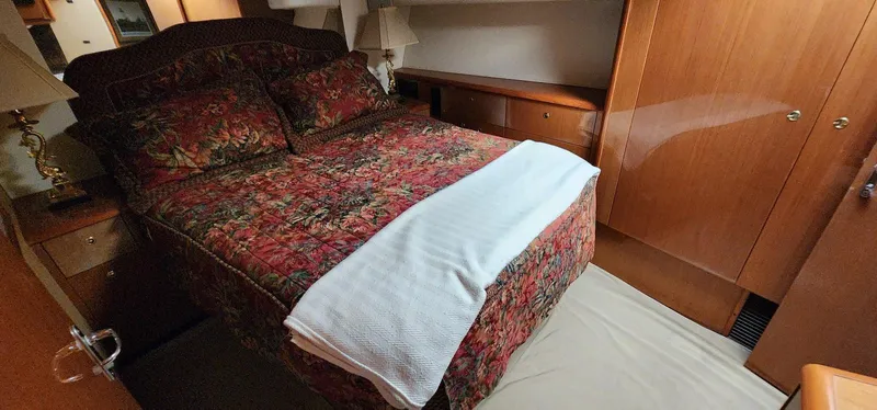 Slide: The Image of Luxurious bedroom interior of 2000 Viking 55 Convertible yacht with floral bedding. - 18