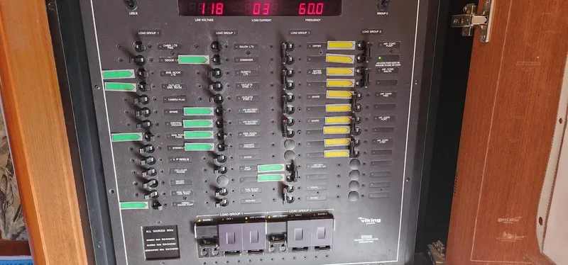 Slide: The Image of Electrical panel on a 2000 Viking 55 Convertible boat, displaying various switches and indicators. - 20