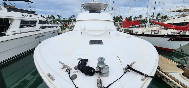 Slide: The Image of 2000 Viking 55 Convertible yacht docked in marina, surrounded by other boats. - 4
