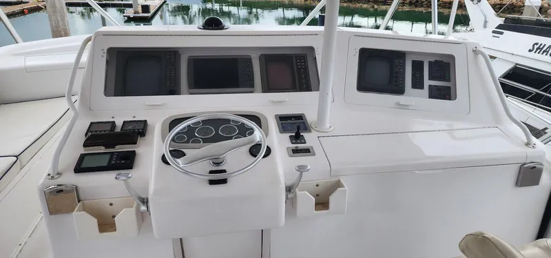 Slide: The Image of Control panel of a 2000 Viking 55 Convertible yacht with multiple navigation screens. - 7