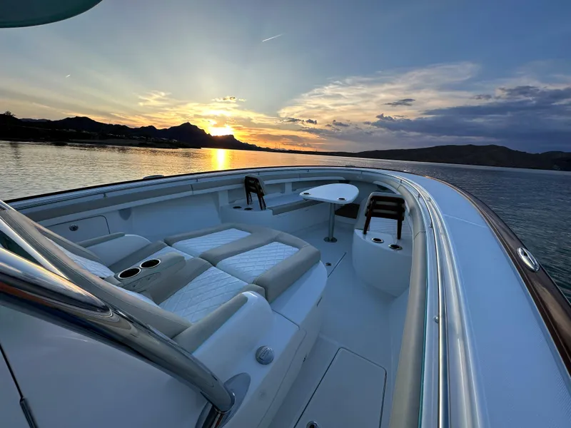 Slide: The Image of 2025 Mag Bay 43 Center Console boat at sunset on calm waters. - 10