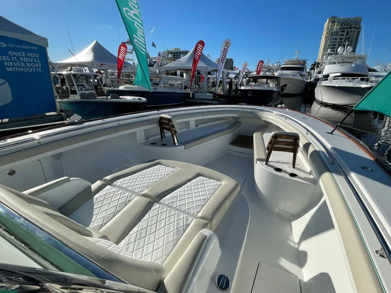 Slide: The Image of 2025 Mag Bay 43 Center Console boat at a marina with luxurious seating. - 11