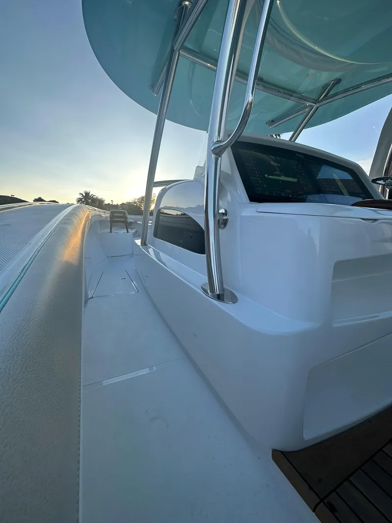 Slide: The Image of 2025 Mag Bay 43 Center Console boat, sleek white design, modern helm, and spacious deck. - 24
