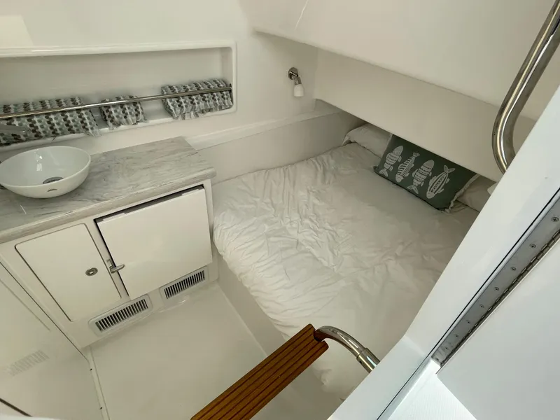 Slide: The Image of 2025 Mag Bay 43 Center Console cabin with bed and sink. - 26