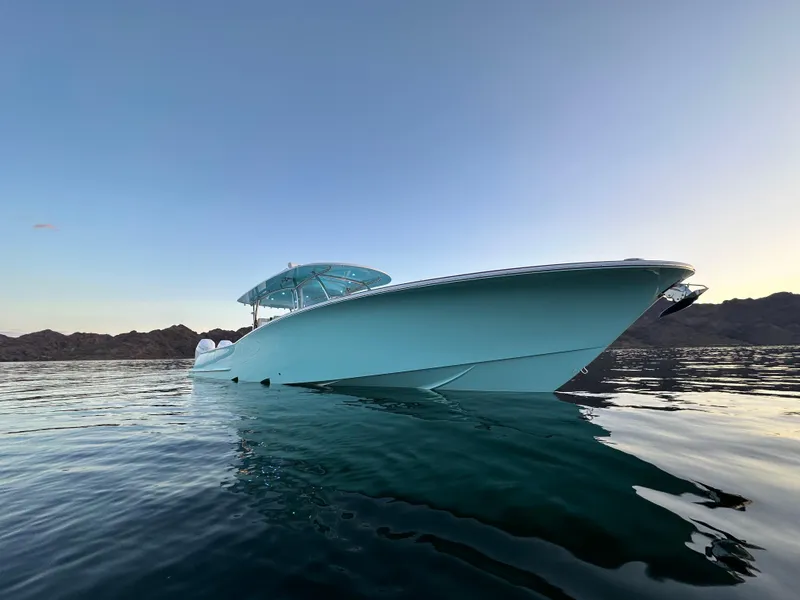 Slide: The Image of 2025 Mag Bay 43 Center Console boat on calm water at sunset. - 3