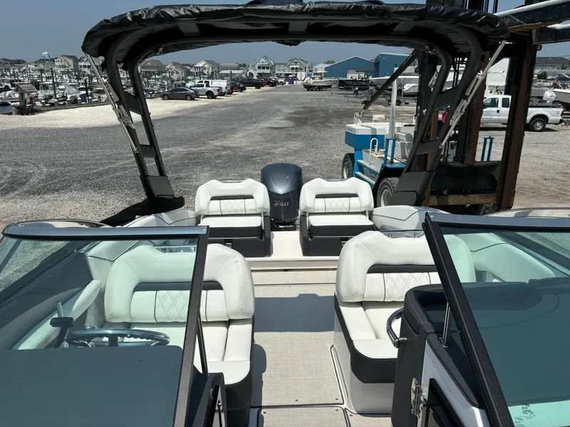 Slide: The Image of 2025 Regal LX4 boat with white leather seats docked at a marina. - 11