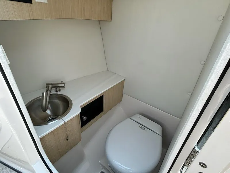 Slide: The Image of Compact bathroom in 2025 Regal LX4 boat with sink and toilet. - 7