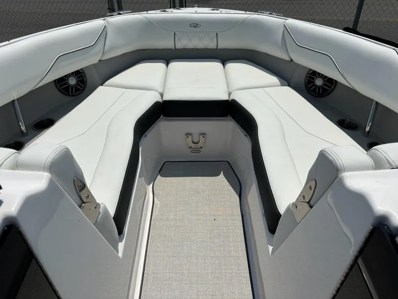 Slide: The Image of 2025 Regal LX4 boat interior with white cushioned seating and built-in speakers. - 8