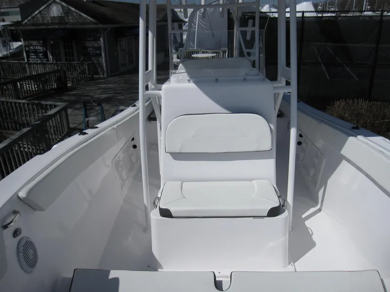Slide: The Image of 2023 Clearwater 2300 boat interior with white seating and console. - 12