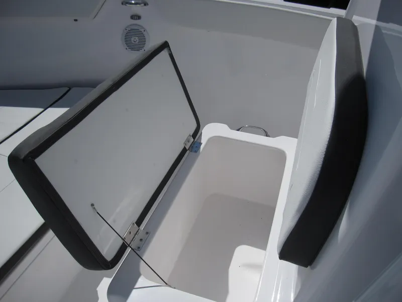 Slide: The Image of Open storage compartment on 2023 Clearwater 2300 boat with cushioned seat. - 14