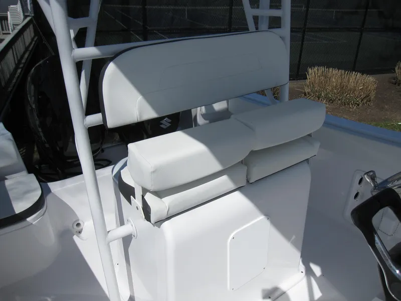 Slide: The Image of 2023 Clearwater 2300 boat with white cushioned seating and console. - 18