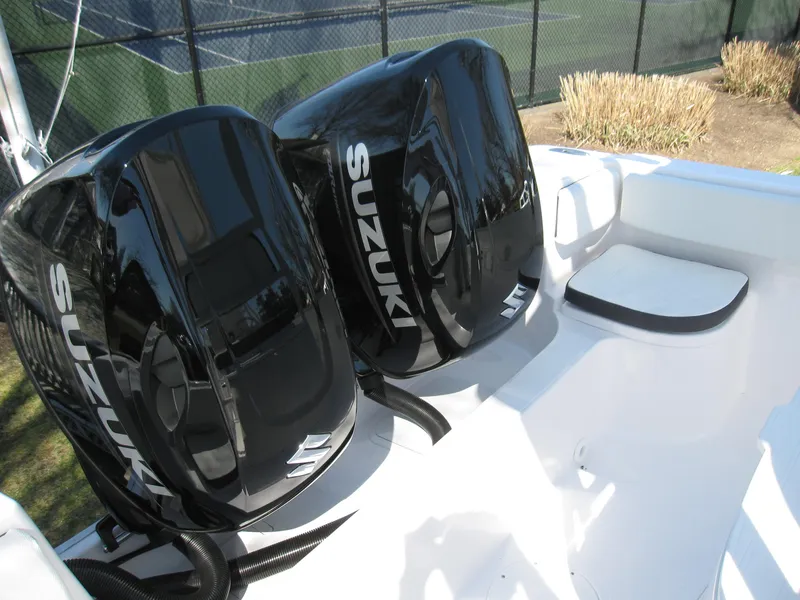 Slide: The Image of 2023 Clearwater 2300 boat with dual Suzuki outboard engines. - 23