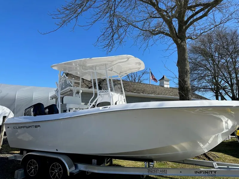 Slide: The Image of 2023 Clearwater 2300 boat on trailer, white hull, outdoor display. - 28