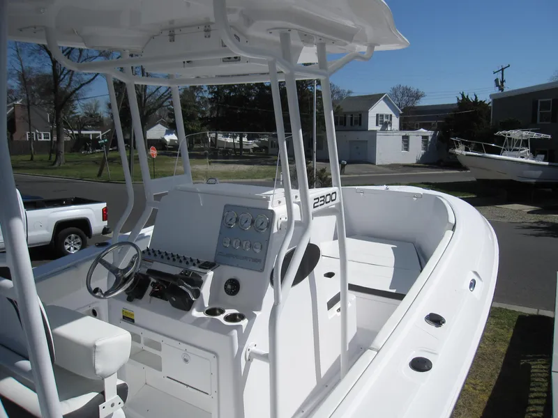 Slide: The Image of 2023 Clearwater 2300 boat with center console and white interior. - 6
