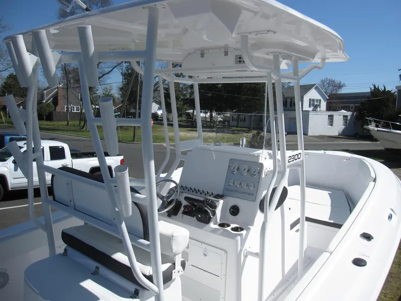 Slide: The Image of 2023 Clearwater 2300 center console boat with white interior and T-top. - 7
