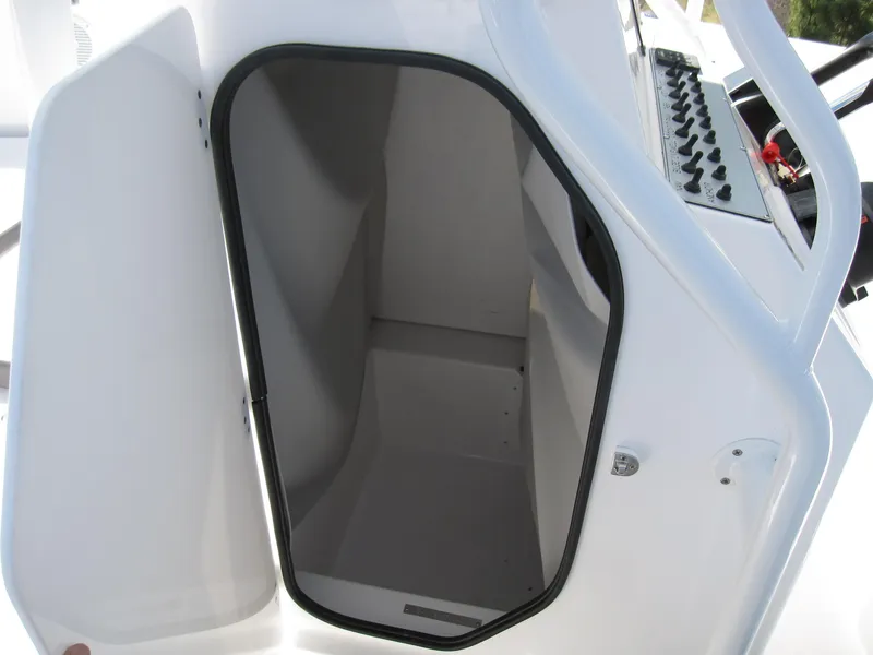 Slide: The Image of Open storage compartment on a 2023 Clearwater 2300 boat. - 16