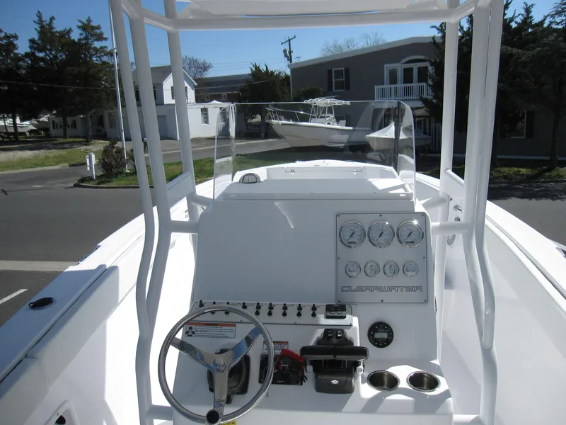 Slide: The Image of 2023 Clearwater 2300 boat dashboard with steering wheel and control panel. - 20