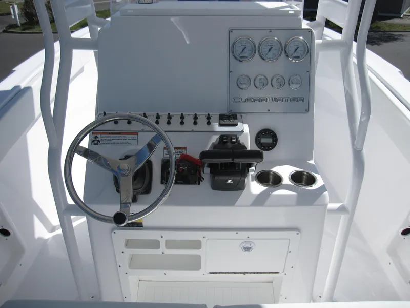 Slide: The Image of Clearwater 2300 boat dashboard, 2023 model, featuring steering wheel, gauges, and controls. - 21