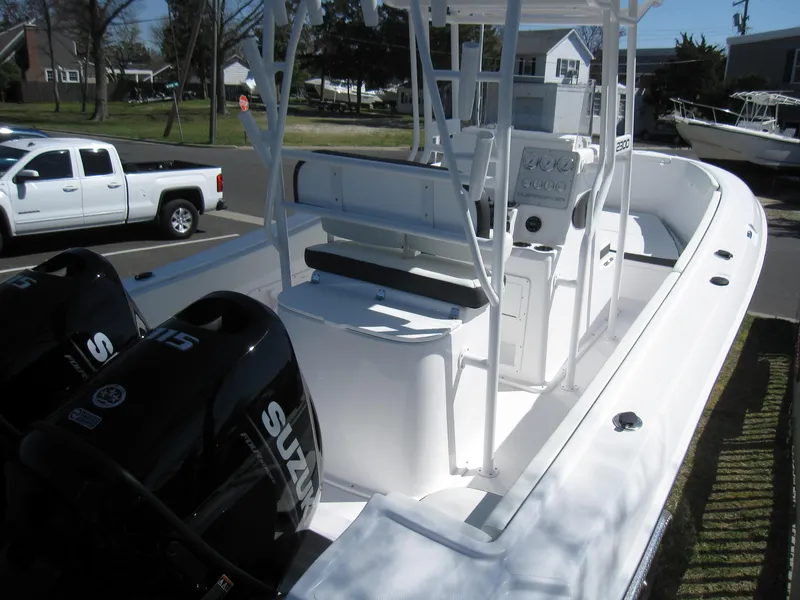 Slide: The Image of 2023 Clearwater 2300 boat with dual Suzuki engines, white interior, and center console. - 5