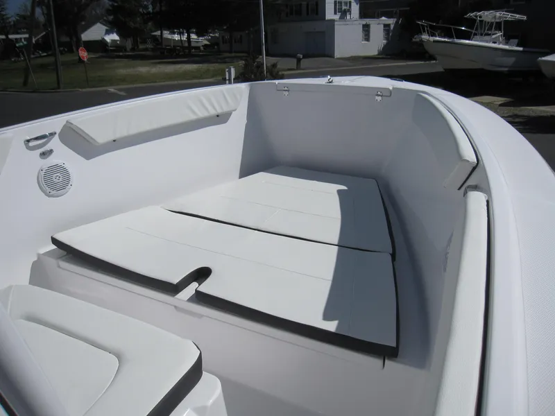 Slide: The Image of 2023 Clearwater 2300 boat interior with cushioned seating and deck. - 8