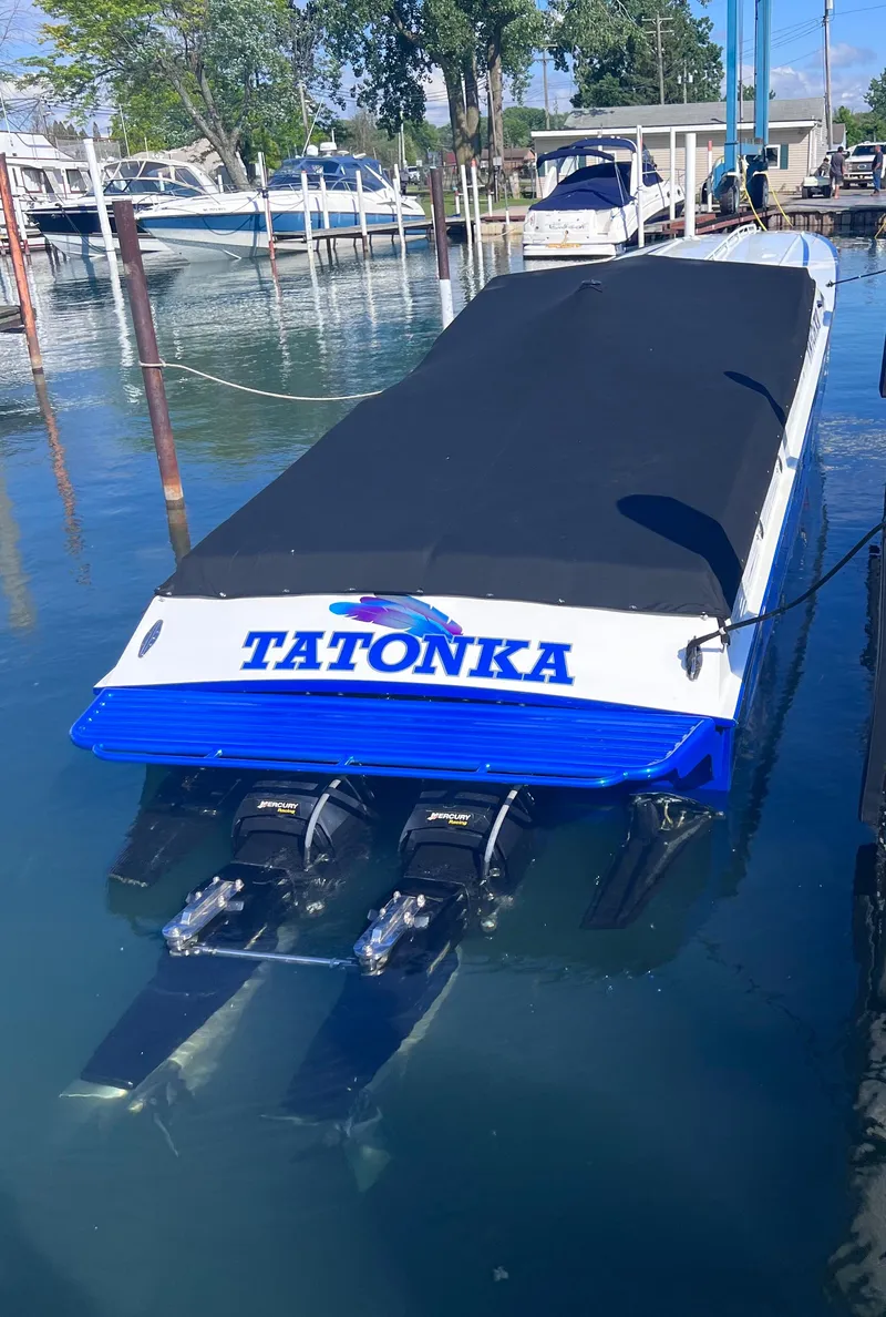 Slide: The Image of 1994 Apache 41 boat named Tatonka docked in marina. - 11