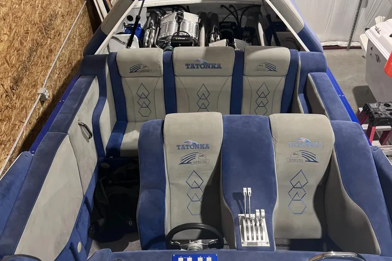 Slide: The Image of 1994 Apache 41 boat interior with blue and gray seats and visible engine. - 3