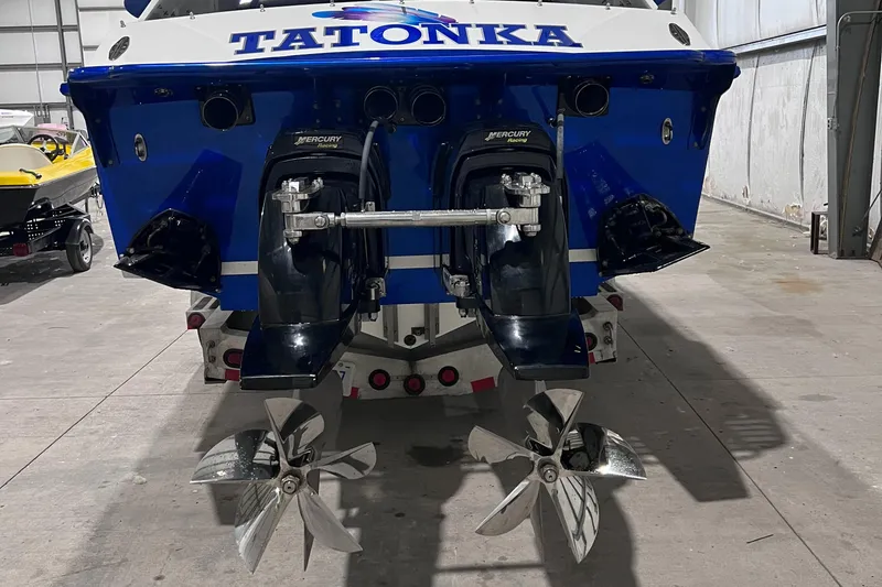 Slide: The Image of 1994 Apache 41 boat with dual propellers in a garage. - 4