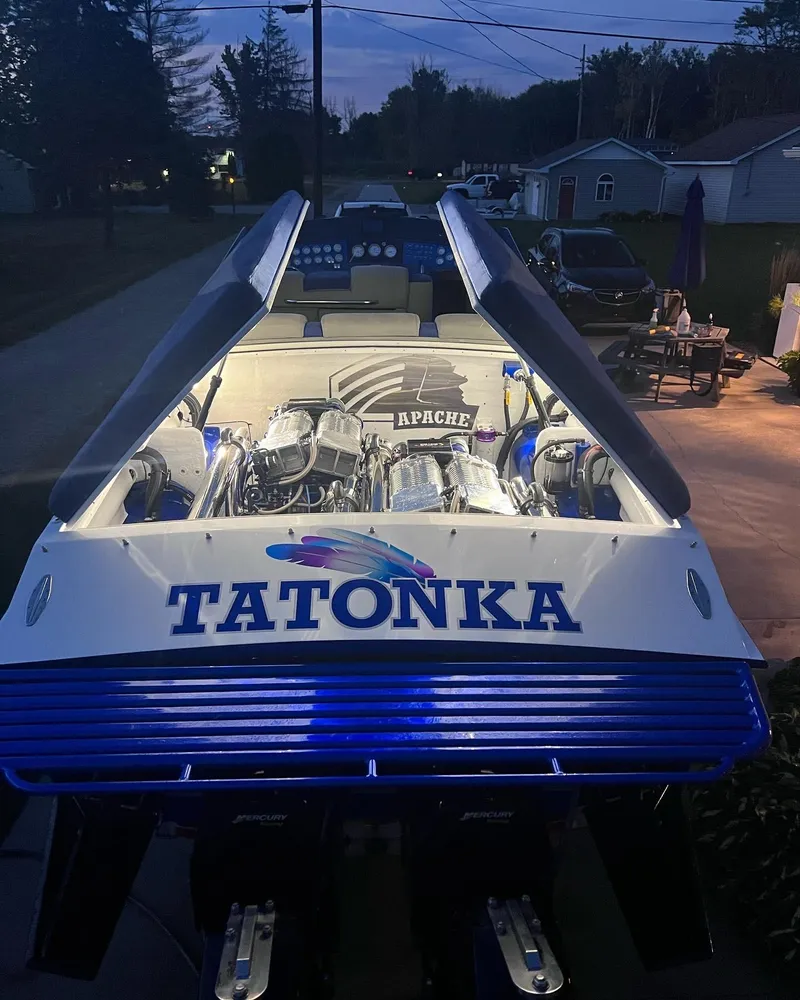 Slide: The Image of 1994 Apache 41 boat named Tatonka with illuminated engine at night. - 9