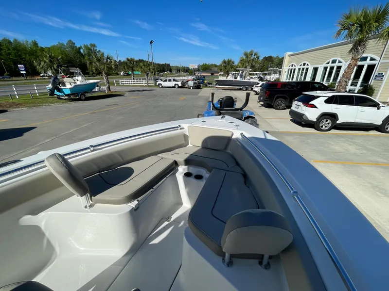 Slide: The Image of 2024 Key West 239 FS boat with spacious seating, parked in a dealership lot. - 17