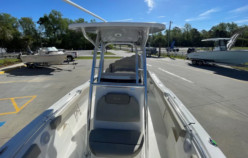 Slide: The Image of 2024 Key West 239 FS boat, front seating area, docked at a marina. - 5