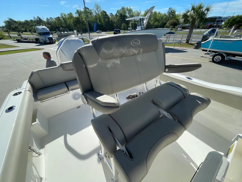 Slide: The Image of 2024 Key West 239 FS boat with comfortable seating in a marina. - 8