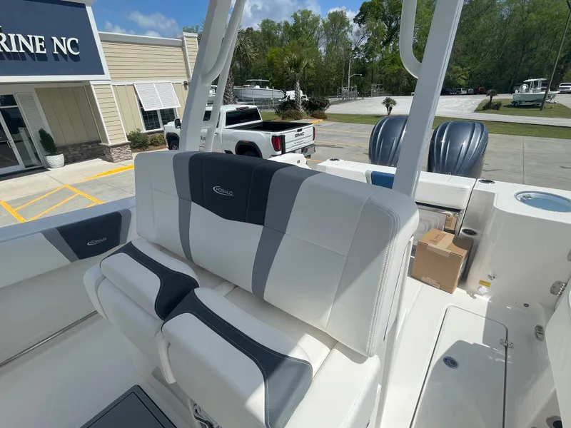 Slide: The Image of 2023 Robalo 270 boat interior with cushioned seating and dual outboard motors. - 14
