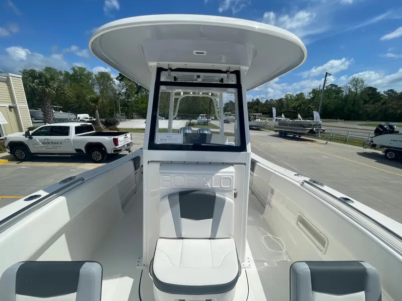 Slide: The Image of 2023 Robalo 270 boat with center console and seating, parked on a lot. - 21