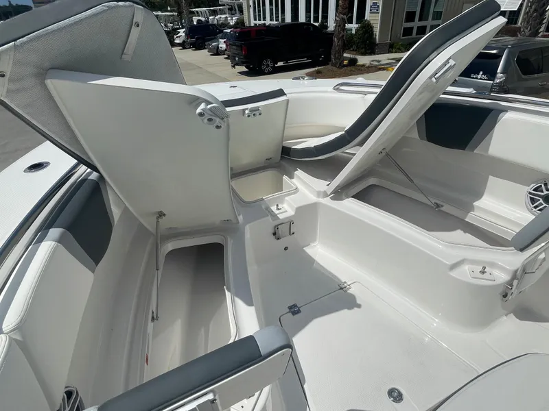 Slide: The Image of 2023 Robalo 270 boat interior with open storage compartments and seating. - 24