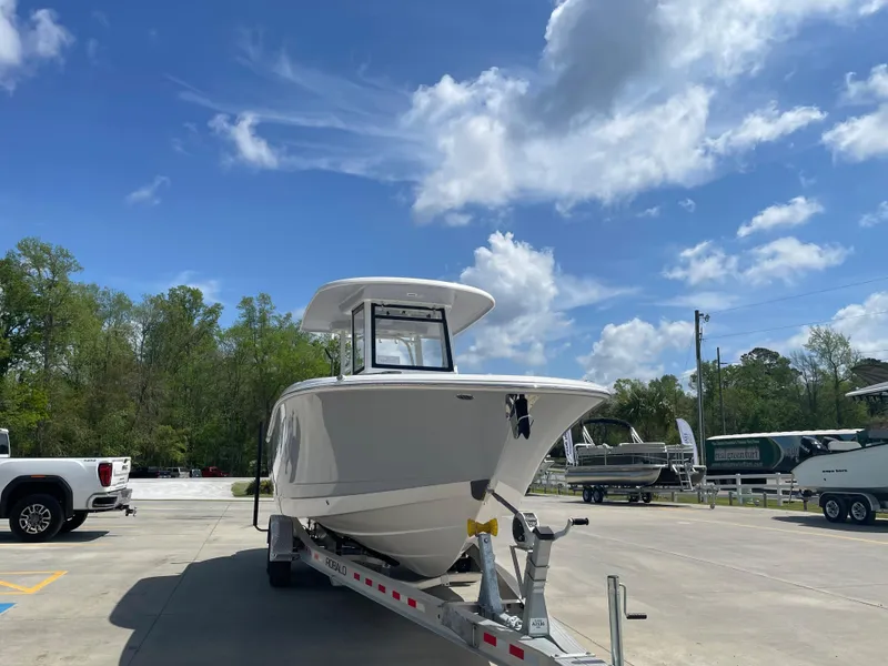 Slide: The Image of 2023 Robalo 270 boat on trailer under blue sky. - 5