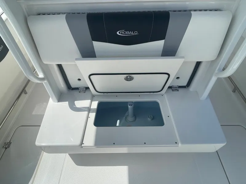 Slide: The Image of 2023 Robalo 270 boat interior with storage compartment and seating. - 9