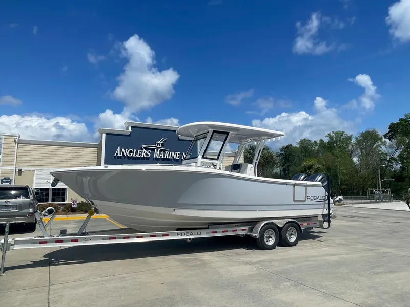 Slide: The Image of 2023 Robalo 270 boat on trailer at Anglers Marine dealership. - 0