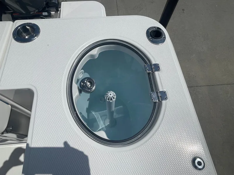 Slide: The Image of 2023 Robalo 270 boat livewell with clear lid and stainless steel fittings. - 11